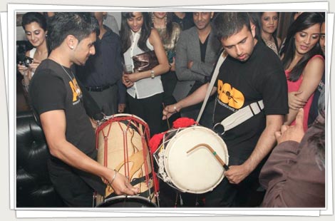 Dhol players performing at a party